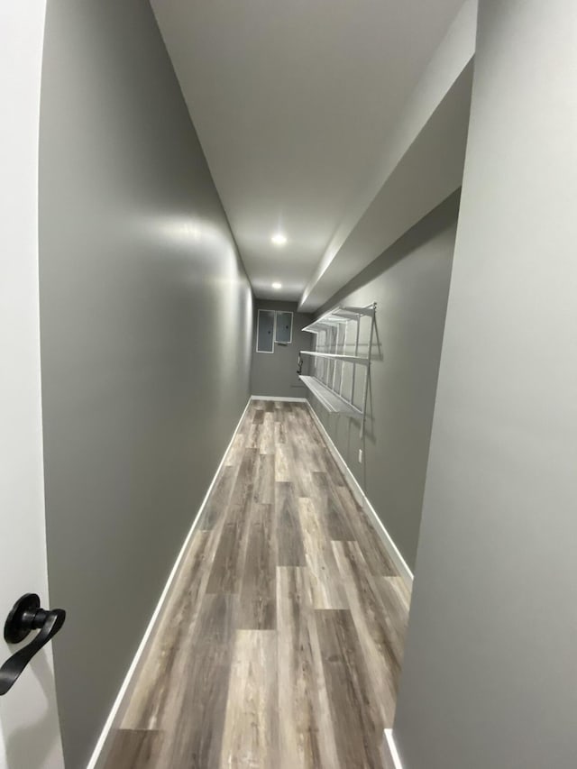 hallway with hardwood / wood-style flooring