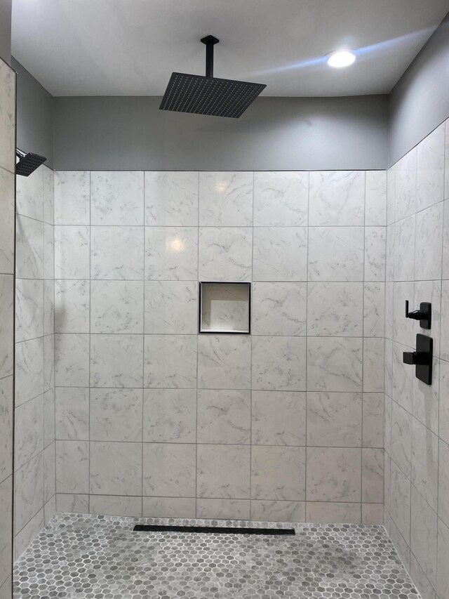 bathroom with tiled shower