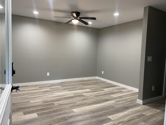 spare room featuring ceiling fan and light hardwood / wood-style flooring