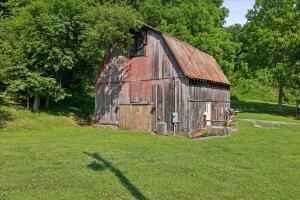 view of barn with a lawn