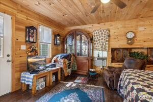 bedroom featuring wood ceiling, wooden walls, and wood finished floors