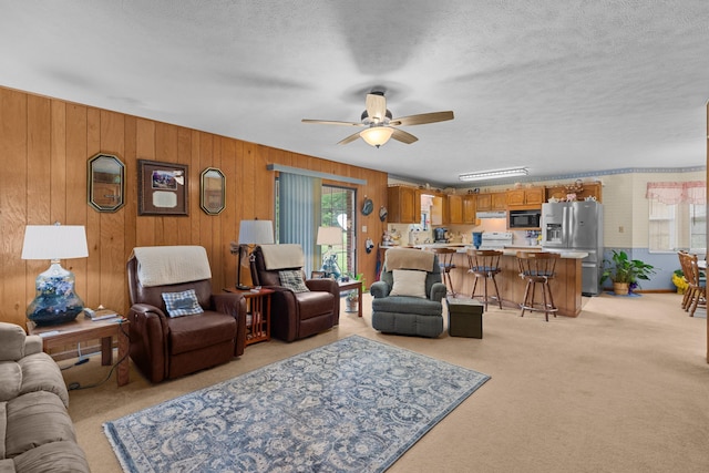 4715/4685 Old Kentucky Rd, Morristown, TN 37814 - living area featuring light carpet, a ceiling fan, a textured ceiling, and wooden walls