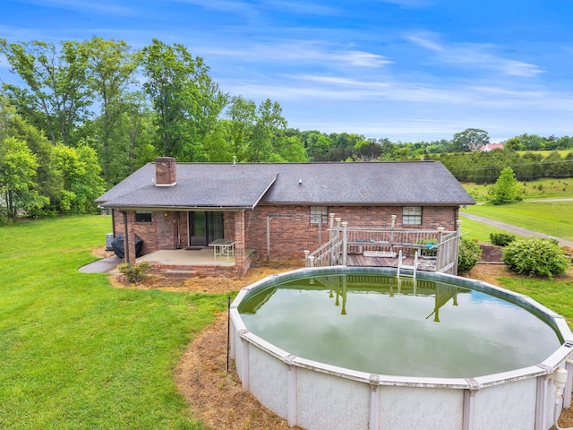 4715/4685 Old Kentucky Rd, Morristown, TN 37814 - rear view of house featuring roof with shingles, brick siding, a chimney, a yard, and a deck