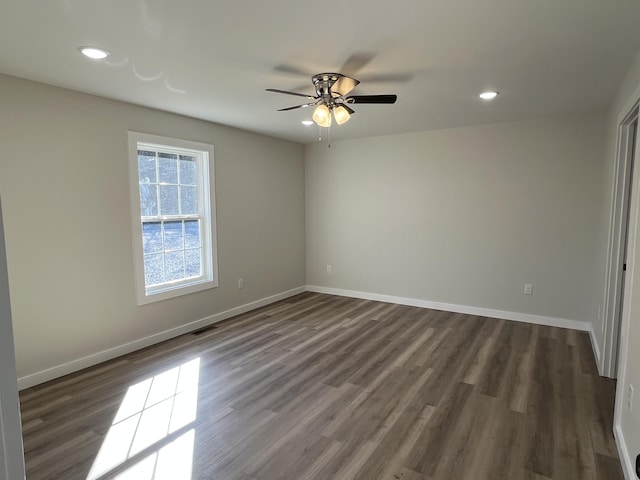 unfurnished room with recessed lighting, dark wood-style flooring, ceiling fan, and baseboards