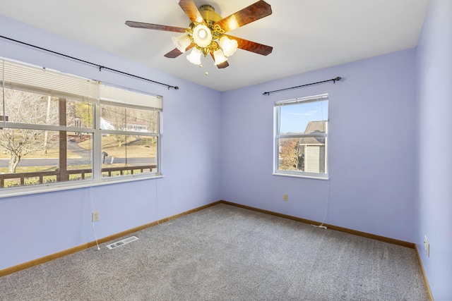 spare room with ceiling fan and carpet floors