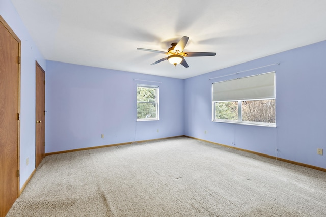 unfurnished room featuring ceiling fan and carpet flooring