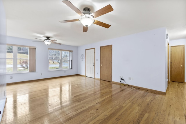 interior space featuring light wood-type flooring, multiple closets, and ceiling fan