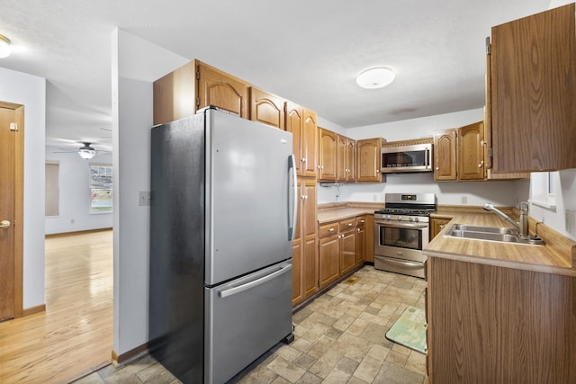 kitchen with ceiling fan, appliances with stainless steel finishes, and sink