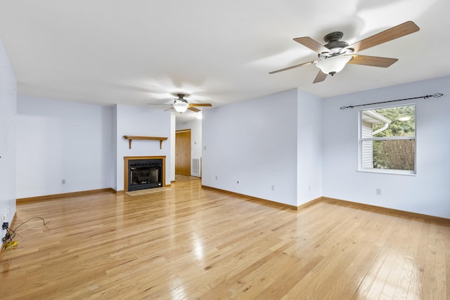 unfurnished living room featuring ceiling fan and light hardwood / wood-style flooring