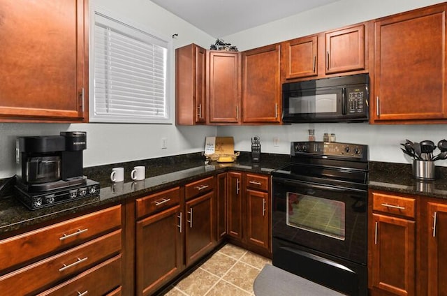 kitchen with black appliances, light tile patterned floors, and dark stone counters