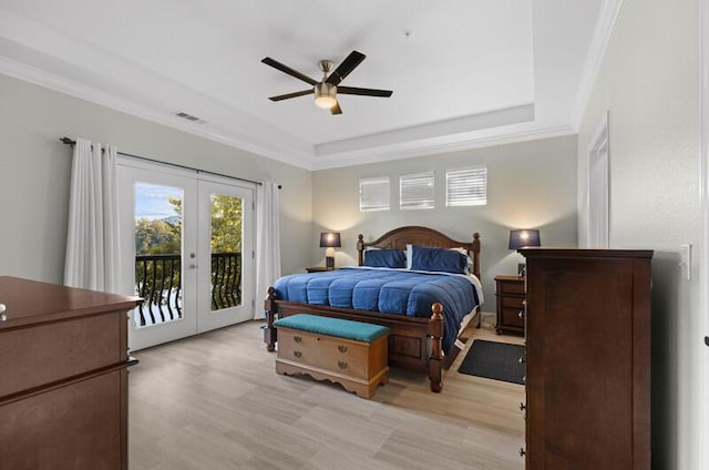 bedroom featuring access to exterior, french doors, light wood finished floors, visible vents, and ornamental molding