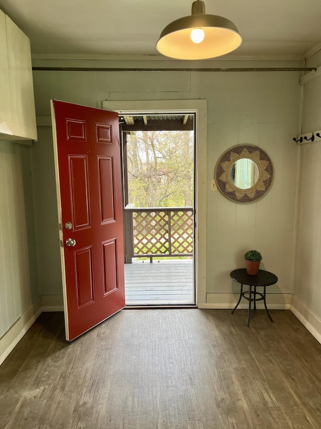 doorway to outside with hardwood / wood-style flooring and ornamental molding