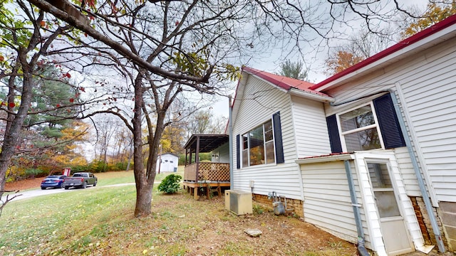 view of side of home with a lawn