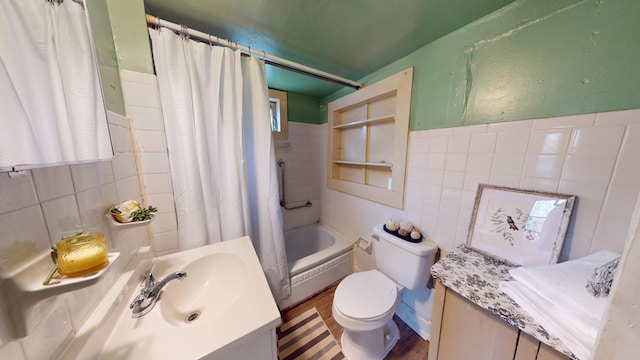 full bathroom featuring shower / tub combo, vanity, toilet, and tile walls