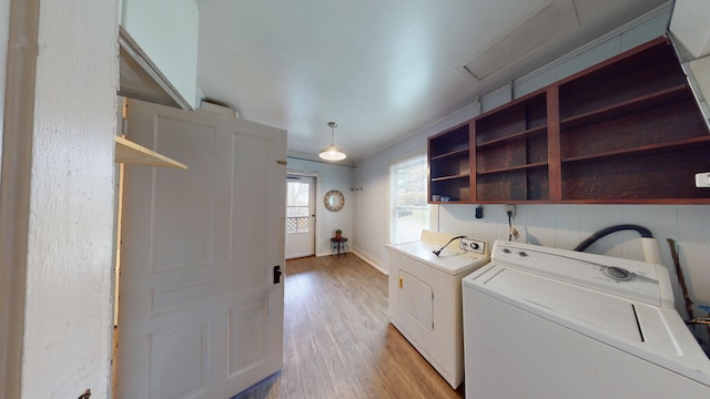 laundry room with light hardwood / wood-style floors and separate washer and dryer