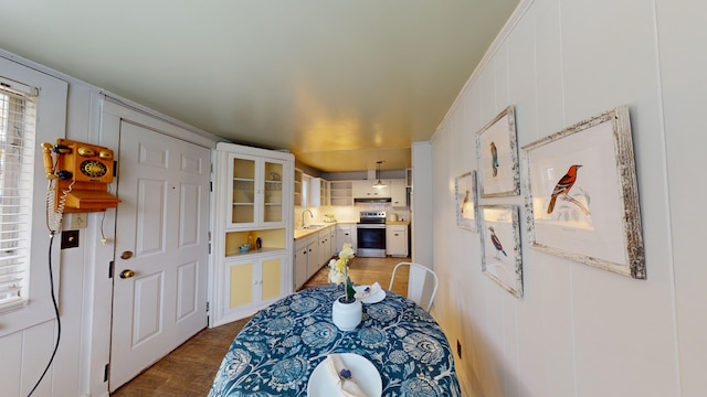 dining room with hardwood / wood-style flooring and sink