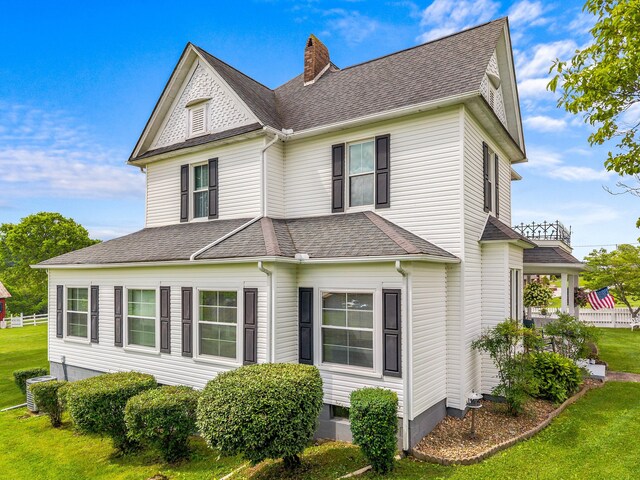 989 E Dumplin Valley Rd, Jefferson City, TN 37760 - view of home's exterior with a chimney, a lawn, and a shingled roof