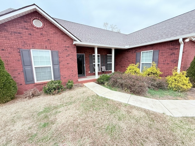 ranch-style home featuring a front yard and a porch