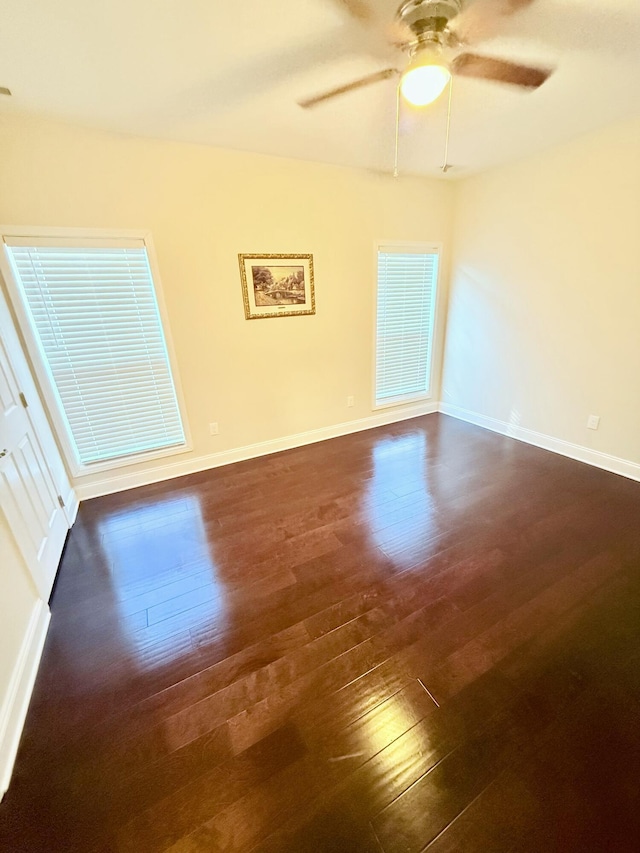 spare room featuring dark hardwood / wood-style floors and ceiling fan