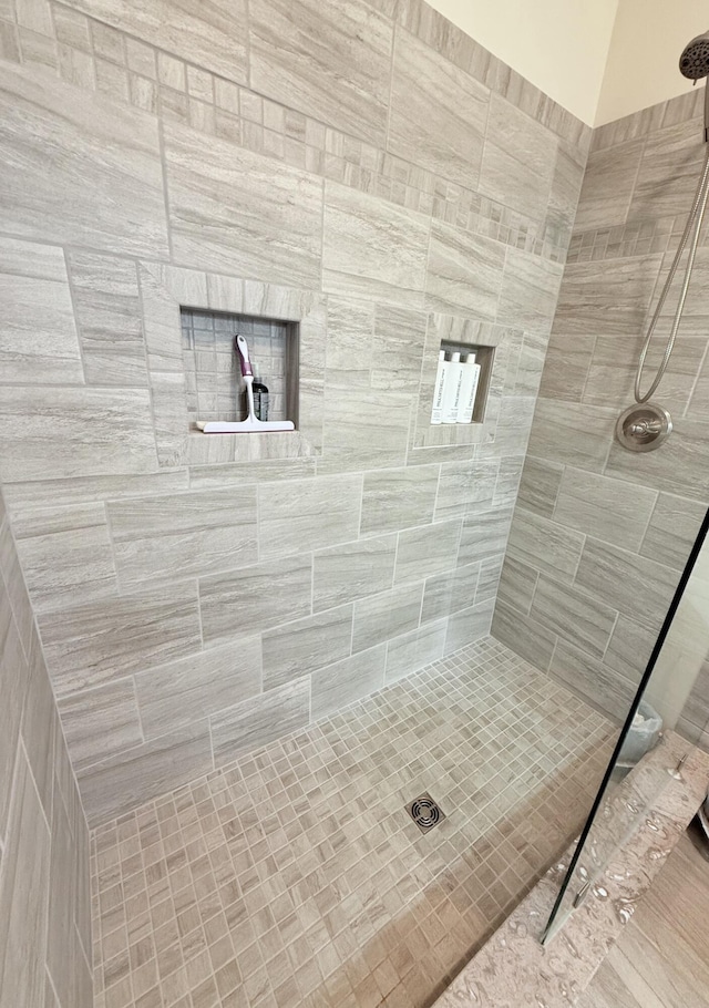 bathroom with a tile shower