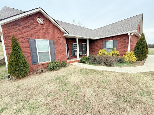 single story home with a front yard and a porch