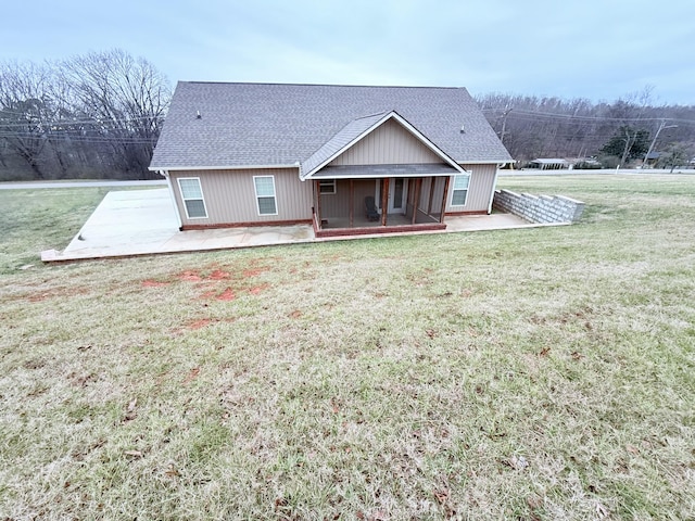 rear view of house featuring a patio, a sunroom, and a yard