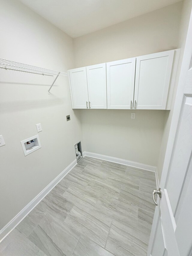 washroom featuring cabinets, hookup for an electric dryer, and hookup for a washing machine