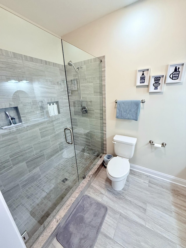 bathroom featuring walk in shower and toilet