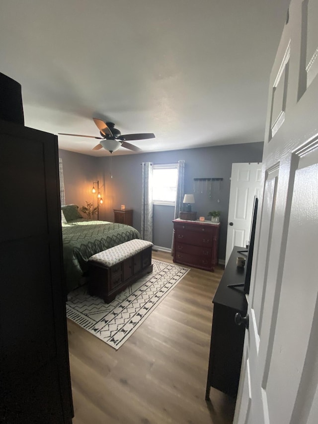 bedroom with ceiling fan and light wood finished floors