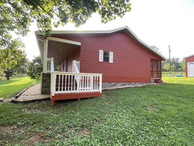 view of side of home featuring a deck and a yard