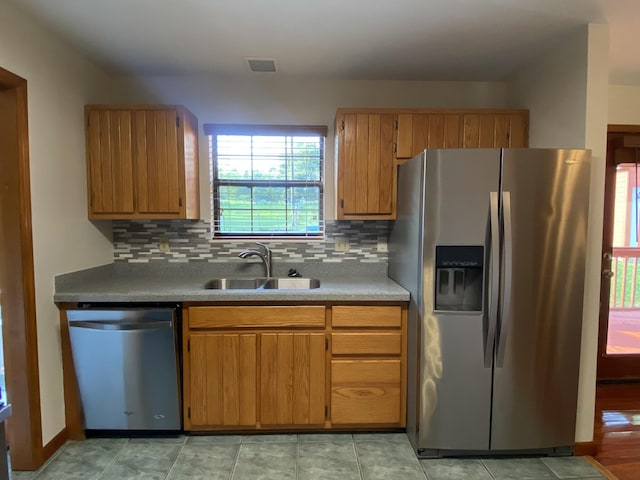 kitchen featuring backsplash, sink, and stainless steel appliances