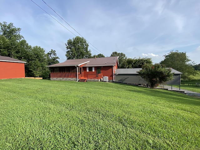 view of yard featuring central AC and a porch