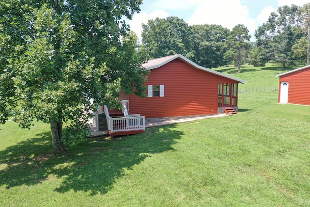 view of yard with an outdoor structure and a wooden deck