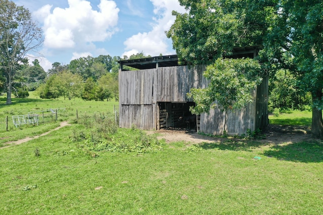 view of outdoor structure featuring a lawn