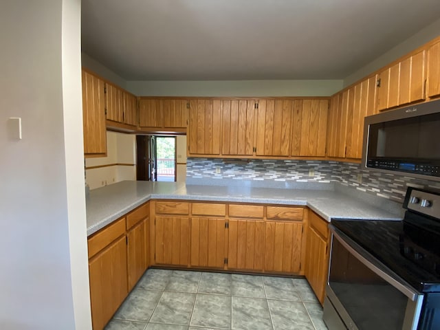 kitchen featuring tasteful backsplash and stainless steel appliances