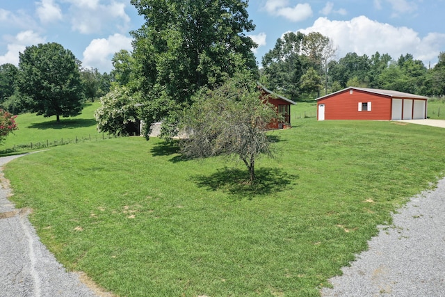 view of yard featuring a garage and an outdoor structure