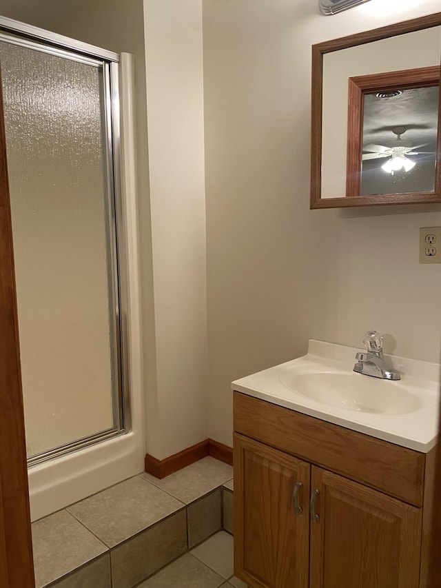 bathroom with tile patterned flooring, vanity, and an enclosed shower