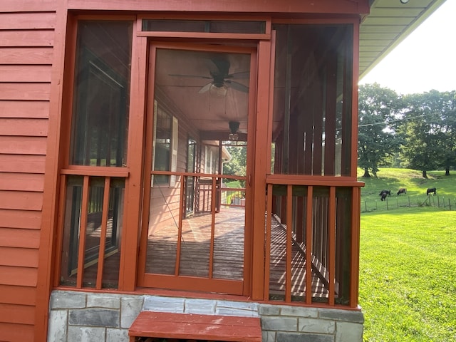 deck with ceiling fan and a yard