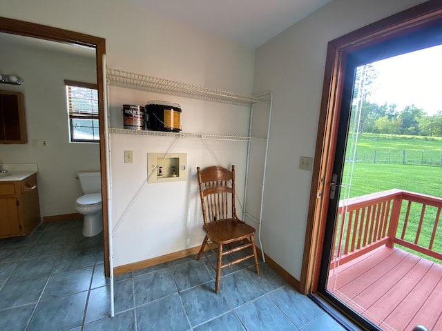 doorway to outside with tile patterned floors and sink