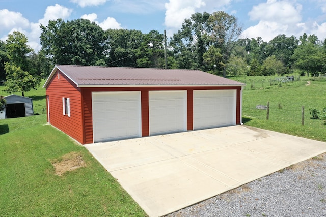 garage featuring a lawn