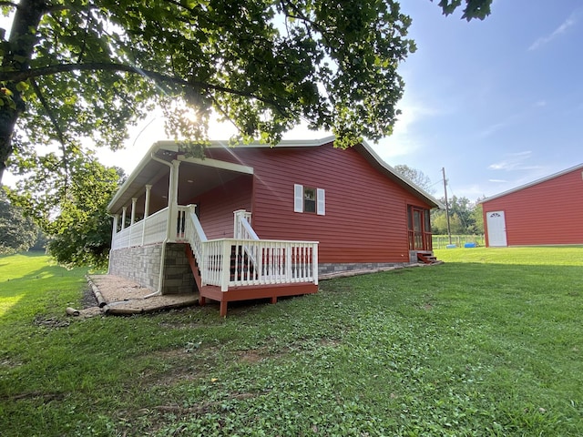 back of property featuring a yard and a wooden deck