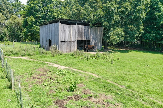 view of outdoor structure featuring a lawn