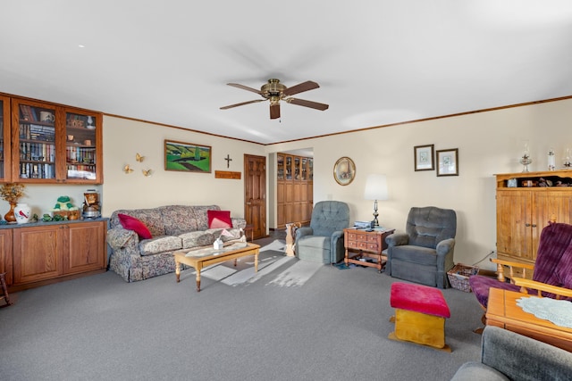 carpeted living room with ceiling fan and crown molding