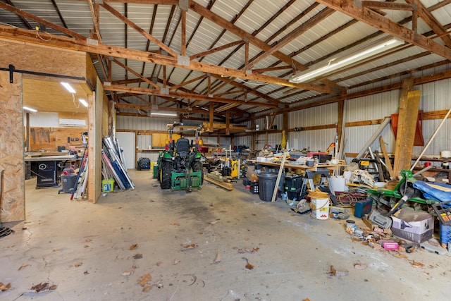 garage with a wall mounted AC and a workshop area