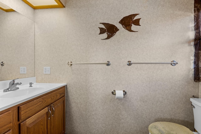 bathroom featuring toilet and vanity