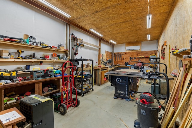 garage with a wall unit AC and a workshop area