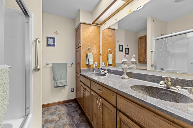 bathroom with a shower with shower door and vanity