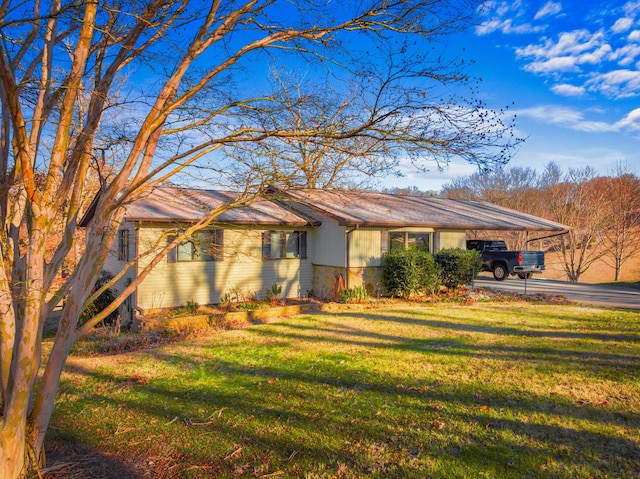 ranch-style house with a front yard and a carport