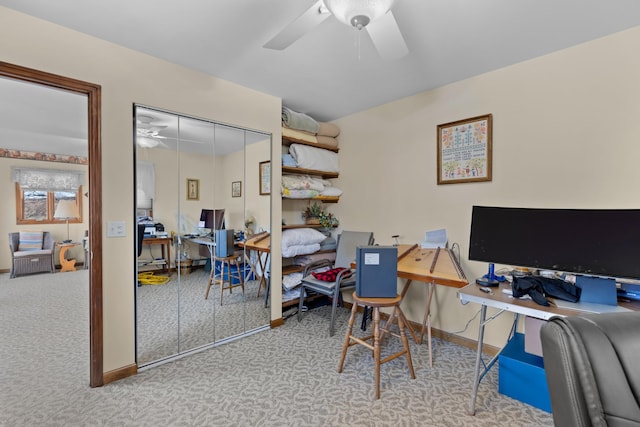 carpeted office featuring ceiling fan