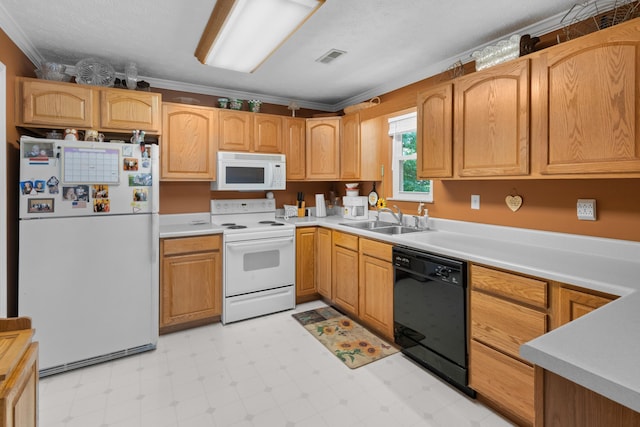 kitchen featuring white appliances, ornamental molding, light countertops, light floors, and a sink